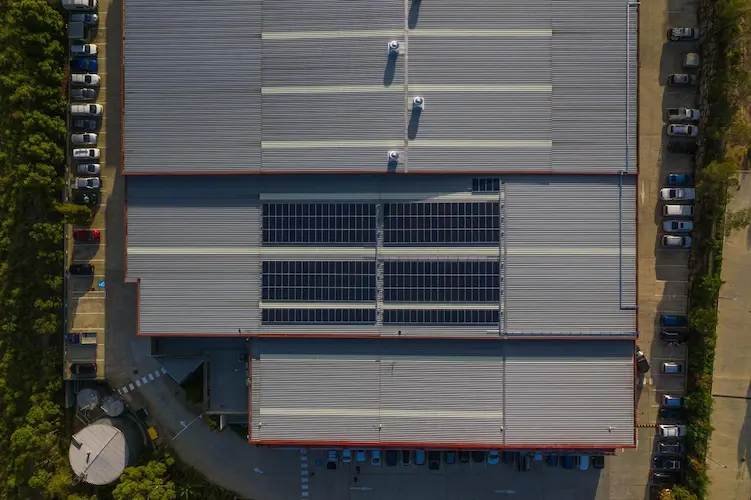 Aerial view of solar panels on the World Gym commercial building, with signage visible