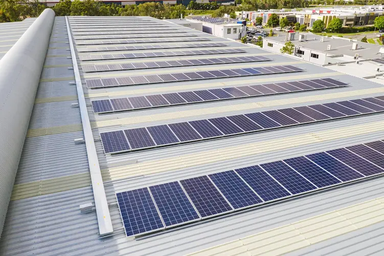 Close-up view of solar panel rows installed on the World Gym commercial roof