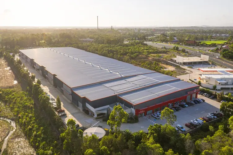 Overhead drone view of solar panels on the World Gym commercial building roof